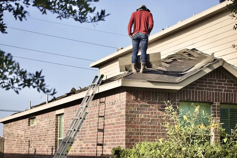 Professional roofer working on a residential roof in Saco